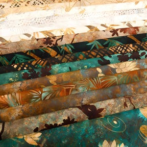 May include: A stack of patterned fabric swatches in various colors, including teal, brown, and gold. The designs feature botanical and abstract patterns, with a focus on leaves and floral motifs. The fabrics are layered, showcasing the variety of textures and designs.