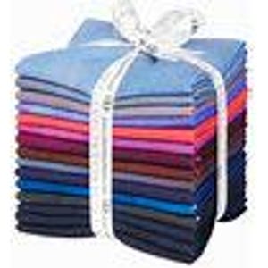 May include: A stack of folded fabric squares in a variety of colours including light blue, purple, pink, magenta, dark red, and navy blue. The fabric stack is tied together with a white ribbon that features repeating text printed in black.