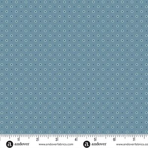 May include: Blue fabric with a repeating pattern of small white and dark blue floral designs. The fabric has a ruler along the bottom edge with the Andover Fabrics logo.