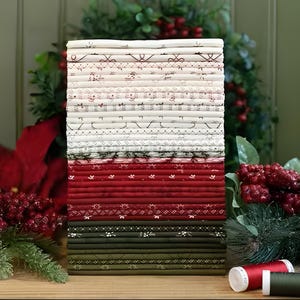 May include: A vertical stack of folded fabric pieces in a colour palette of cream, deep red, and dark olive green. The fabrics feature various small-scale patterns including floral motifs, geometric lines, and dots, arranged in a neat, layered column.