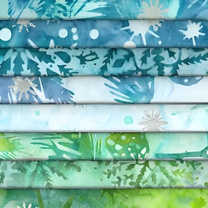 May include: A stack of fabric with various shades of blue and green, featuring leaf and floral patterns. Some fabrics have silver accents. The color palette ranges from deep navy to light teal, creating a layered effect.