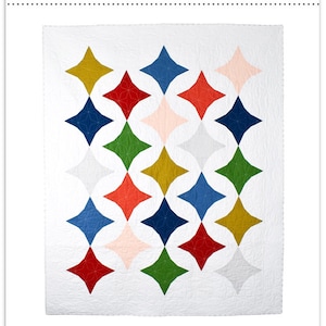 May include: A quilt pattern called "Zesty" by Eliane Bergmann. The pattern features a geometric design of colorful diamonds on a white background. The pattern is available in sizes for baby, throw, twin, full/queen, and king.