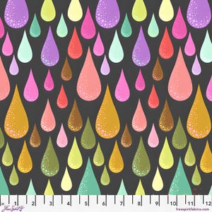 May include: A fabric pattern featuring colorful, stylized teardrops in shades of pink, yellow, green, and purple against a dark gray background. The teardrops have a textured, dotted appearance. The fabric is marked with a ruler in inches.