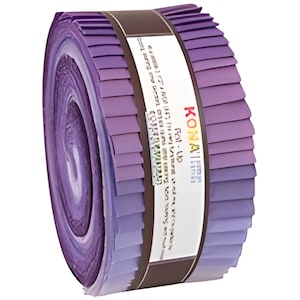 May include: A roll of fabric strips in shades of purple, from light lavender to deep violet. The fabric is neatly rolled and secured with a brown band and a white label with text. The product is labeled "KONA".