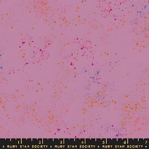 May include: A fabric with a light purple background, speckled with small, irregular dots in shades of orange, pink, blue, and purple. The text "RUBY STAR SOCIETY" is printed at the bottom.
