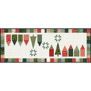 May include: A green and red patchwork table runner with a Christmas theme. The runner features a row of green and red houses, a green Christmas tree, and a row of red and green pennants.
