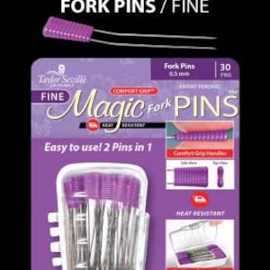 May include: A pack of 30 purple and silver Magic Fork Pins, a type of sewing pin with a forked head. The pack features a close-up of the pins in a clear plastic container, along with the brand name and product description. The pins are heat resistant and have comfort grip handles.
