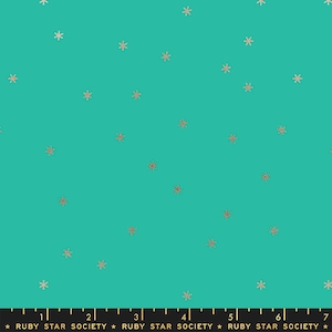 Puede incluir: Tela turquesa con un patrón disperso de pequeñas estrellas doradas. La tela tiene una regla impresa en la parte inferior con el texto "RUBY STAR SOCIETY" repetido.