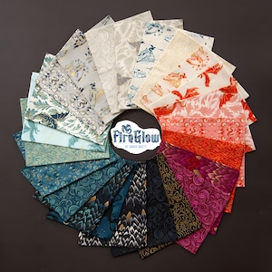 May include: A circular arrangement of fabric squares in various colors and patterns. The fabrics feature designs of dragons, landscapes, and abstract motifs. The color palette includes blues, greens, reds, and purples. The center of the arrangement displays the text "FireGlow by Sarah Watts".