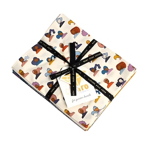 May include: A bundle of fat quarter fabric with a repeating pattern of colorful stylized faces on an off-white background. The bundle is tied with a black ribbon and includes a tag that reads "for quarter bundle".