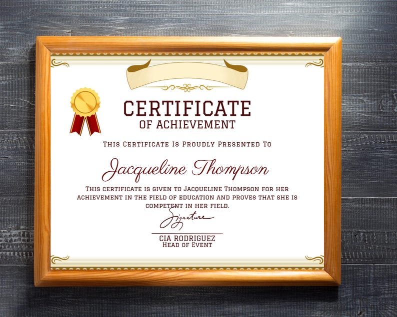 May include: A framed certificate of achievement with a gold seal and red ribbon. The certificate is presented to Jacqueline Thompson for her achievement in the field of education. The signature is from CIA Rodriguez, Head of Event.