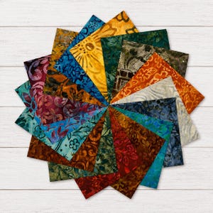 May include: A collection of square fabric swatches arranged in a circular starburst pattern. The fabric pieces feature various batik patterns in a diverse color palette including yellow, orange, red, purple, blue, green, brown, and grey tones.