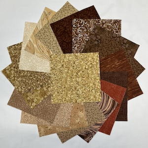 May include: A collection of assorted fabric squares in shades of brown, tan, and beige, arranged in a circular pattern. The squares feature various patterns, including swirls, floral designs, and textured effects. Ideal for quilting or crafting projects.
