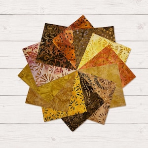 May include: A collection of square fabric swatches arranged in a circular starburst pattern. The fabric pieces feature various batik-style prints in shades of brown, gold, yellow, and rust, displaying patterns of dots, swirls, and floral motifs.