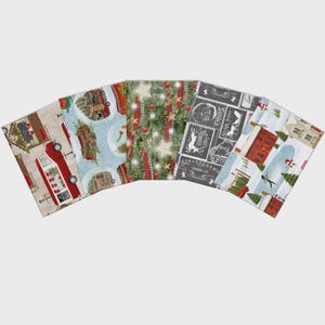 May include: A collection of five fabric squares with Christmas-themed patterns. Designs include a red truck, snow globes, Christmas trees with ornaments, a chalkboard-style print with reindeer, and a snowy village scene. The fabrics are arranged in a fan shape.