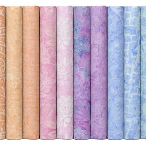 May include: A collection of rolled fabric bundles in a spectrum of colors, ranging from pastel yellows and oranges to pinks, purples, and blues. Each bundle displays a unique patterned design, creating a visually diverse and colorful display. The fabric appears to be cotton or a similar material.