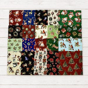 May include: A square fabric quilt composed of twenty-five distinct panels featuring various Christmas motifs. Patterns include Santa Claus, reindeer, nutcrackers, snowmen, cardinals, poinsettias, pine trees, wrapped gifts, and ornaments in red, green, blue, black, and cream.