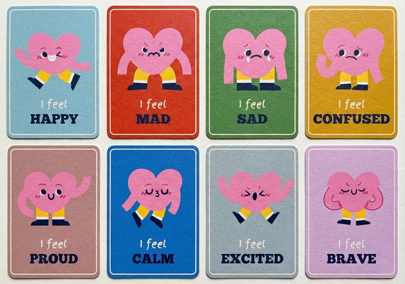 May include: Set of eight colorful cards, each featuring a pink heart character expressing different emotions. The cards include text like "Happy," "Mad," "Sad," and "Confused." Each card has a unique background color.