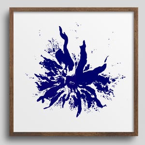 May include: A framed print featuring a vibrant blue abstract floral design. The artwork, set against a white background, is enclosed in a square, wooden frame. The bold, splattered design evokes a sense of energy and movement, suitable for modern decor.