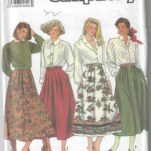 May include: Simplicity sewing pattern number 9876 for sizes US 5 (16-24) and EUR. U5 (44-52). The pattern shows four women wearing different skirts and blouses. The skirts are all knee-length and have different patterns and colors. The blouses are all long-sleeved and have different styles.