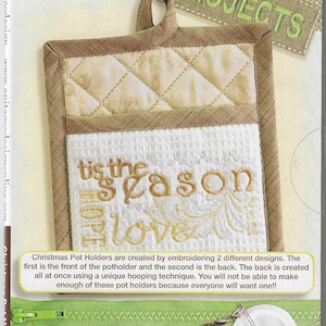 May include: A close-up of a beige and brown quilted pot holder with the text "tis the season of love" embroidered in gold thread. The pot holder is on a background with the text "Anita Goodesign" and "Projects".