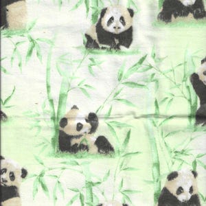 May include: A light green fabric featuring a repeating pattern of pandas and bamboo. The pandas are black and white, and the bamboo is green. The pandas are depicted in various poses, some sitting and some standing.