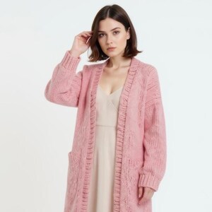 Fashionable look: a long pink cardigan and a light slip dress.
