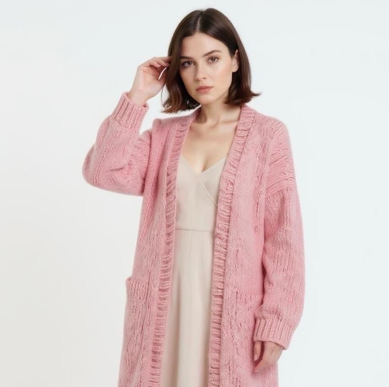Fashionable look: a long pink cardigan and a light slip dress.