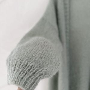 A soft mint color cardigan, perfect for layering.