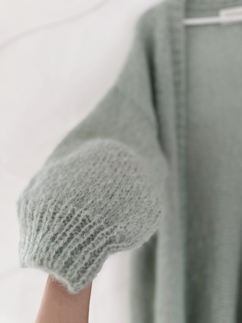 A soft mint color cardigan, perfect for layering.