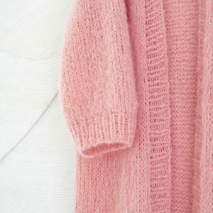 A chunky knit pink cardigan
