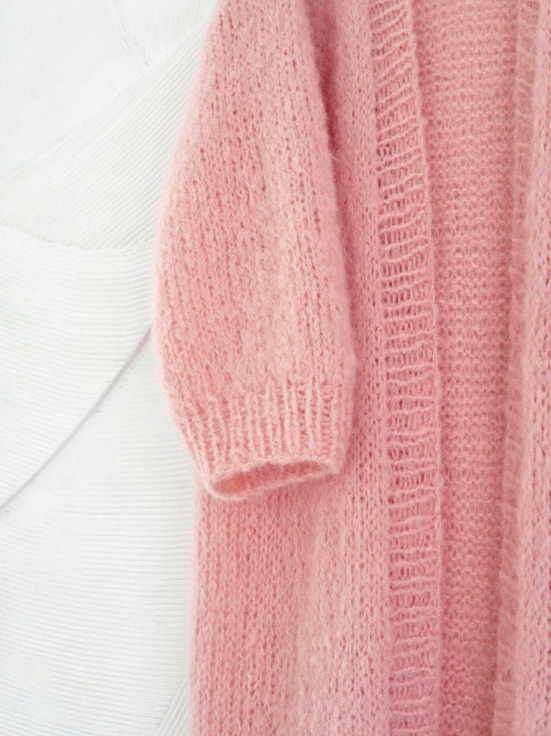 A chunky knit pink cardigan