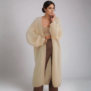 Full-length image of a woman in a beige cardigan