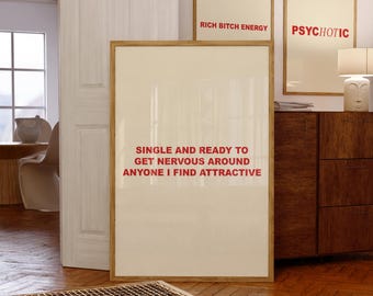 May include: A white framed print with the text "Single and ready to get nervous around anyone I find attractive" in red letters. The print is hanging on a wall in a room with a wooden floor.
