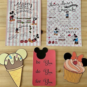 May include: A collection of Disney-themed paper cutouts and illustrations. Includes a Mickey Mouse sandwich design, a Minnie Mouse cupcake recipe, an ice cream cone, a card with the text "be You do You for You", and a cupcake.