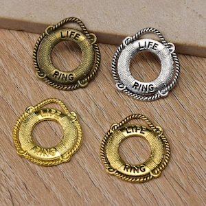 May include: Four life ring charms in gold and silver tones. Each charm features the words "LIFE RING" engraved on the front.