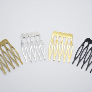 May include: Four hair combs in different colors: gold, silver, black, and bronze. Each comb has five teeth.