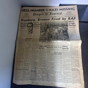 May include: A vintage Oregon Journal newspaper dated Monday, May 12, 1941. The front page features the headline 'HESS, NUMBER 3 NAZI, MISSING' and 'Hamburg, Bremen Fired by RAF', alongside a black and white photograph of Westminster Abbey.