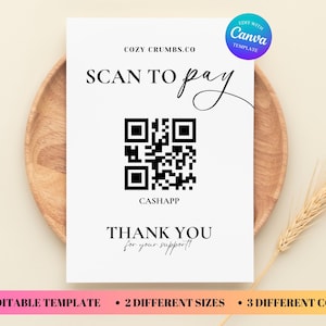 May include: A white card with the text "SCAN TO pay" and a QR code for CashApp. The card also says "THANK YOU for your support!" and "COZY CRUMBS.CO". The card is on a wooden plate with a wheat stalk.