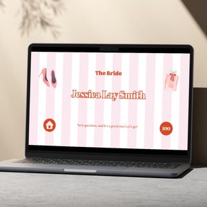 May include: A laptop screen displaying a pink and white striped background with the text "The Bride Jessica Lay Smith" in orange. The screen also shows a pink shoe, a pink perfume bottle, a red house icon, and a red circle with the number 100 inside.