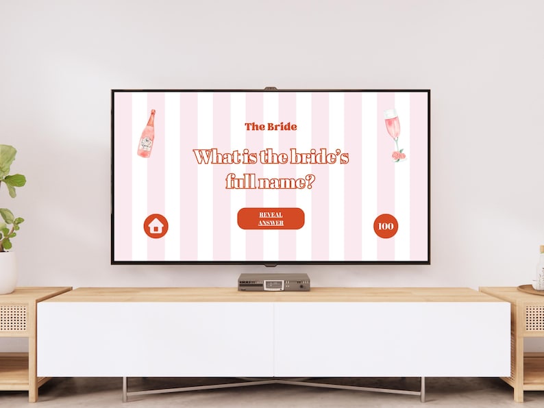 May include: A pink and white striped screen displaying a bridal shower game. The question is "What is the bride's full name?" with a pink bottle of champagne, a pink champagne flute, and a pink flower on the screen. The screen also has a button that says "Reveal Answer" and a score of 100.