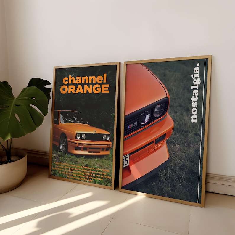 May include: Two framed posters with a vintage aesthetic featuring a close-up of an orange BMW M3 car. The poster on the left has the text "channel ORANGE" and the poster on the right has the text "nostalgia."