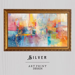 May include: Abstract art print in a gold frame with a colourful geometric design featuring shades of blue, yellow, pink, orange, and green. The print is titled "SILVER ART PRINT DESIGN".