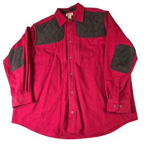 May include: A red long-sleeved shirt featuring dark grey quilted shoulder and elbow patches. The shirt has a button-down front, a collar, and buttoned cuffs. The shirt is made of a soft, durable material.