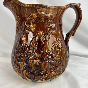 May include: A set of three ceramic mugs with a speckled, matte finish. The mugs are in shades of cream, light gray, and dark gray. Each mug has a simple, minimalist design and a rounded handle.