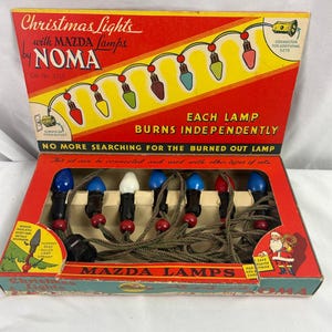 May include: A vintage Noma Christmas light set in a red and yellow cardboard box. The box features text including Christmas Lights with MAZDA lamps by NOMA, Each lamp burns independently, and No more searching for the burned out lamp.