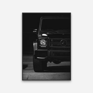 May include: A black SUV with a chrome grill and headlights. The car is parked in a dark setting.