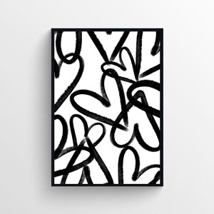 Puede incluir: Impresi&oacute;n de arte abstracto en blanco y negro con un patr&oacute;n de corazones superpuestos. La impresi&oacute;n est&aacute; enmarcada en un marco negro.