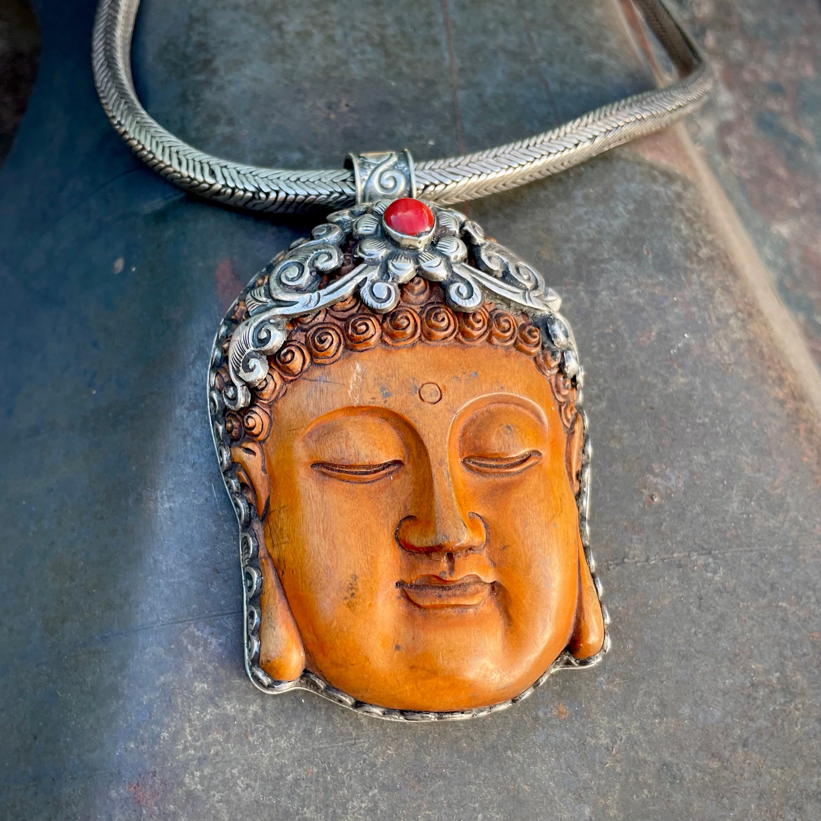 Large Carved Wood Buddha Face Encased in Silver Repousse