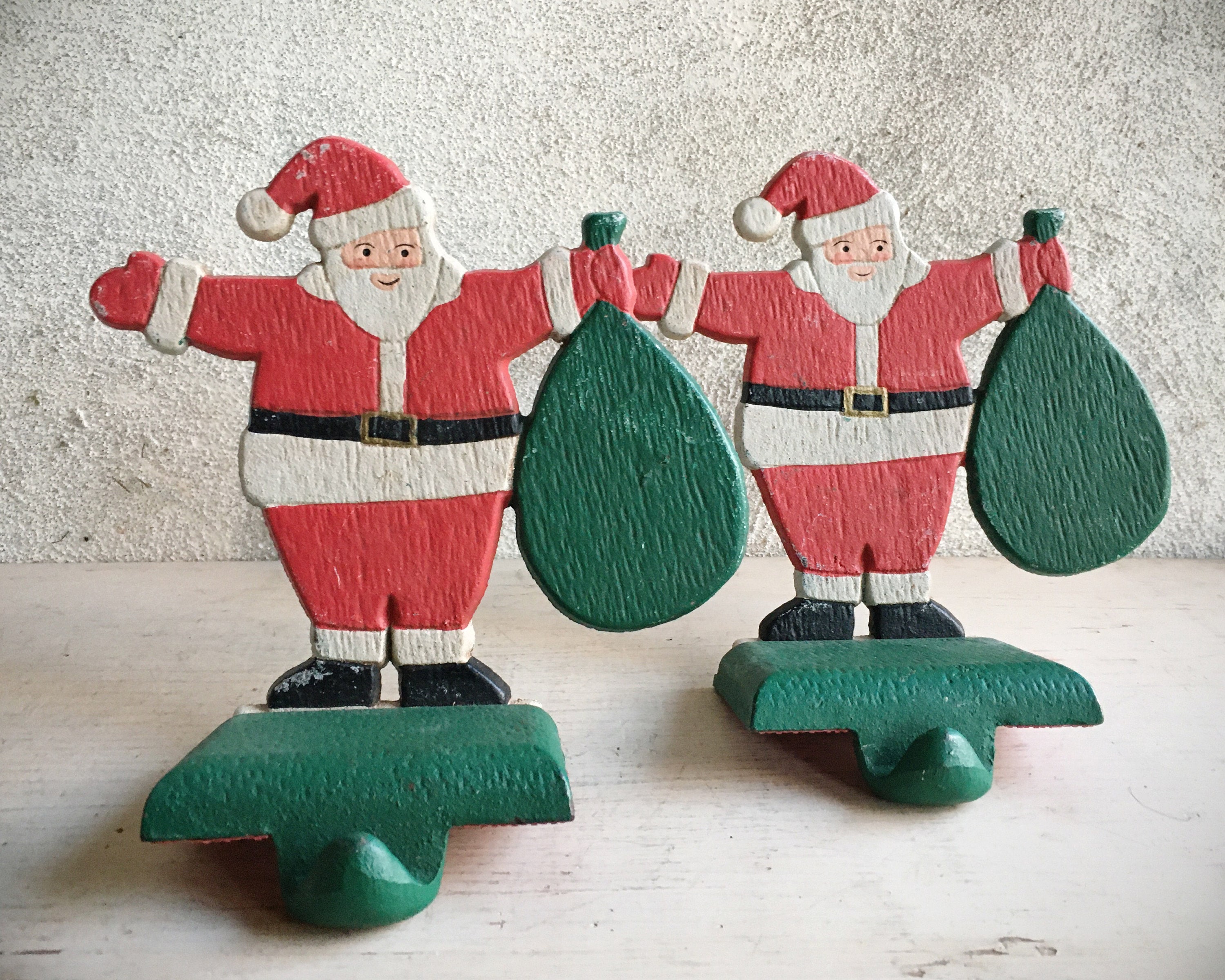 Two Large Cast Iron Santa Claus Christmas Stocking Holders for Mantle